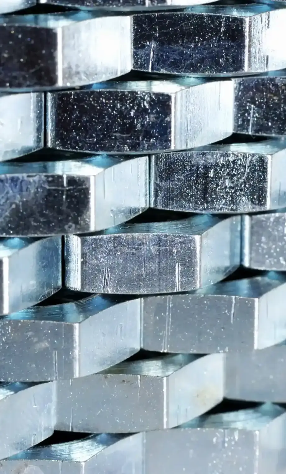 close-up-wall-of-numerous-chrome-metal-nuts-2025-01-29-07-28-07-utc